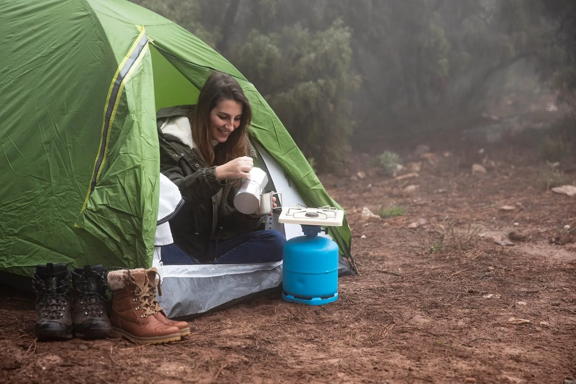 Three-season tent pitched at a campsite with sleeping bag